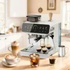 A white espresso machine is shown on a wooden countertop in a kitchen setting, with several cups of coffee and a milk pitcher around it. Produktbild-Vorschau