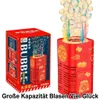 Rote Bubble-Maschine mit goldenen festlichen Designs, die bunte Blasen ausstößt, neben ihrer rot-weißen Verpackung Náhled obrázku produktu
