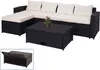 A black poly-rattan sectional sofa with cream cushions and a matching coffee table with storage is displayed on a white background. A small inset image shows the coffee table with its lid open, revealing storage space. Anteprima dell’immagine prodotto