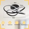 A modern LED ceiling light with a unique swirling design, shown with dimensions and feature icons. Produktbild-Vorschau