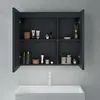 A dark gray bathroom cabinet with its doors open, displaying various toiletries and accessories on its shelves, above a white sink and faucet. Produktbild-Vorschau
