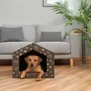 A dog is lying in a dog house in a living room. Náhled obrázku produktu