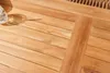 A close-up view of a wooden table surface, showing the grain and texture of the wood. Produktbild-Vorschau