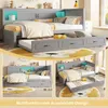 A collage of images showing a gray wooden bed with a pull-out trundle bed and built-in storage, decorated with pillows and blankets. The background includes a lion-themed rug and some decorative items. Podgląd zdjęcia produktu