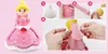 A collage of images showing how to create a doll figure out of modeling clay, with a finished doll on the left. Náhled obrázku produktu