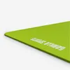 A close-up, angled view of a bright green yoga mat against a white background. Produktbild-Vorschau