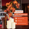 A still life arrangement featuring a vase with artificial flowers and three LED candles in a kitchen-like setting. Produktbild-Vorschau