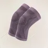 A pair of knee braces on a textured light gray background. Podgląd zdjęcia produktu