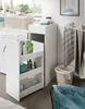 A laundry room scene with a washing machine, a narrow shelving unit filled with cleaning supplies, and a drying rack with towels. Produktbild-Vorschau