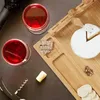 A top-down view of a cheese board with wine, cheese, crackers, and a corkscrew. Náhľad obrázku produktu