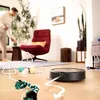 A robot vacuum cleaner navigates around obstacles in a living room, with warning symbols indicating potential issues. Náhled obrázku produktu