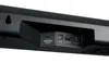 A close-up view of the back panel of a black soundbar, showing various ports and labels. Voir les images du produit