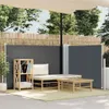 An outdoor patio scene with a retractable side awning, lounge furniture, and a small coffee table. Produktbild-Vorschau