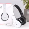 A white and black pair of headphones is shown next to its packaging. Produktbild-Vorschau
