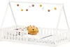 A white wooden house bed with a mattress, pillows, and a decorative garland of balls. Produktbild-Vorschau