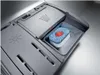 A close-up view of a dishwasher detergent dispenser with a detergent pod inside. Voir les images du produit