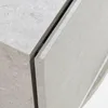 A close-up view of the corner and seam of a piece of furniture, likely a nightstand, showing the texture and material. Anteprima dell’immagine prodotto