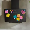 A black kitchen range hood mounted on a wall, decorated with colorful sticky notes and magnets. Voir les images du produit