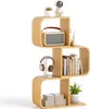 A S-shaped bookshelf with various items on it, including a radio, books, headphones, a plant, and decorative items. Podgląd zdjęcia produktu