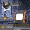 A work light is shown in a rainy urban environment with buildings in the background. Produktbild-Vorschau