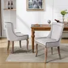 Two dining chairs are placed around a wooden dining table in a well-lit room. Podgląd zdjęcia produktu