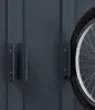 A close-up view of a bicycle wheel mounted on a dark gray wall with a mounting bracket. Náhled obrázku produktu