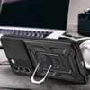 A black phone case with a ring stand is shown on a wooden surface, with a laptop and headphones in the background. Produktbild-Vorschau