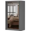 A gray wardrobe with mirrored doors reflecting a bedroom interior. Voir les images du produit