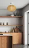 A modern kitchen with wooden cabinets and shelves, featuring a pendant light. Podgląd zdjęcia produktu