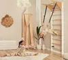 Two children are playing on a wooden climbing frame in a room. Produktbild-Vorschau