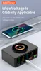 A smartphone is wirelessly charging on a multi-port USB charging hub, which displays real-time power output on its screens. Produktbild-Vorschau