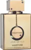 A close-up of a gold-colored perfume bottle with a chain and circular tag. Anteprima dell’immagine prodotto
