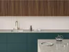 A modern kitchen sink area with dark teal cabinets and wooden upper cabinets. Podgląd zdjęcia produktu