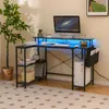 A modern L-shaped desk setup with a computer, monitor, and decorative elements, illuminated by blue LED lights. Produktbild-Vorschau