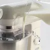 Milk being poured into a stand mixer. Náhled obrázku produktu