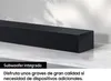 A black soundbar is placed on a white marble surface with soft lighting. Voir les images du produit