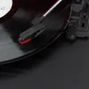 A close-up shot of a record player's tonearm and stylus resting on a vinyl record. Produktbild-Vorschau