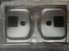 A top-down view of a new, double-basin stainless steel sink, still in its packaging. Podgląd zdjęcia produktu