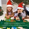 Two young girls wearing Santa hats are lying on a felt Christmas tree decoration, playing with ornaments. Produktbild-Vorschau