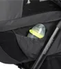 A close-up view of a baby bottle in a pocket on a stroller. Voir les images du produit
