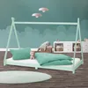 A child's bedroom with a teepee-style bed, bedding, and decorative elements.