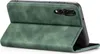 A green flip case for a smartphone is shown from a side-angle, with the front cover folded open. Produktbild-Vorschau