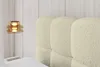A close-up view of a tufted headboard of a bed. Produktbild-Vorschau