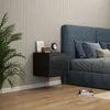 A bedroom scene with a bed, nightstand, and plant. Podgląd zdjęcia produktu