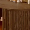 A close-up shot of a wooden desk with a fluted cabinet door and a handle. Produktbild-Vorschau