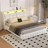 A white upholstered bed with a tufted headboard and integrated LED lighting is shown in a bedroom setting. Produktbild-Vorschau