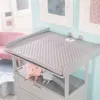 A nursery room with a changing table and stuffed animals. Produktbild-Vorschau