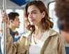People on a train using wireless earbuds. Produktbild-Vorschau