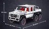 A white toy car model with red interior and black wheels, shown from a side-angle against a dark gray background. Dimensions are indicated with white text and arrows. Anteprima dell’immagine prodotto