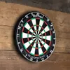 A dartboard mounted on a wooden wall. Podgląd zdjęcia produktu